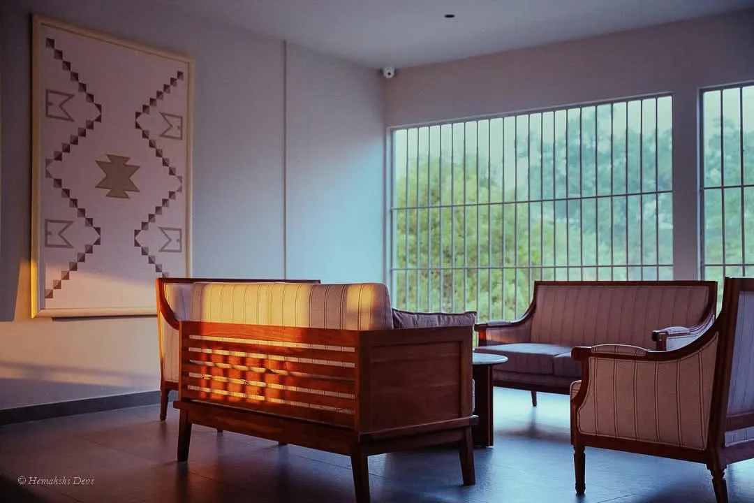 Guest lounge at sunset with a framed woven-pattern digital artwork on the wall